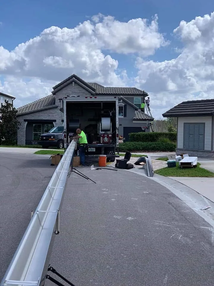 Seamless gutter run out box truck street gray stucco, Sanford